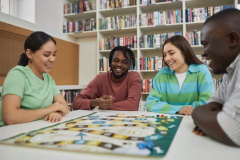 adults playing a board game