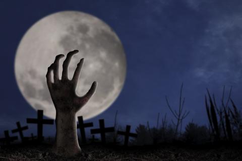 hand coming out of ground with full moon
