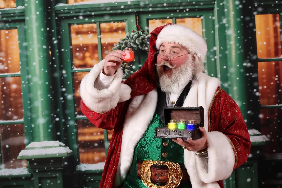 Santa Joey holding up a red jar.